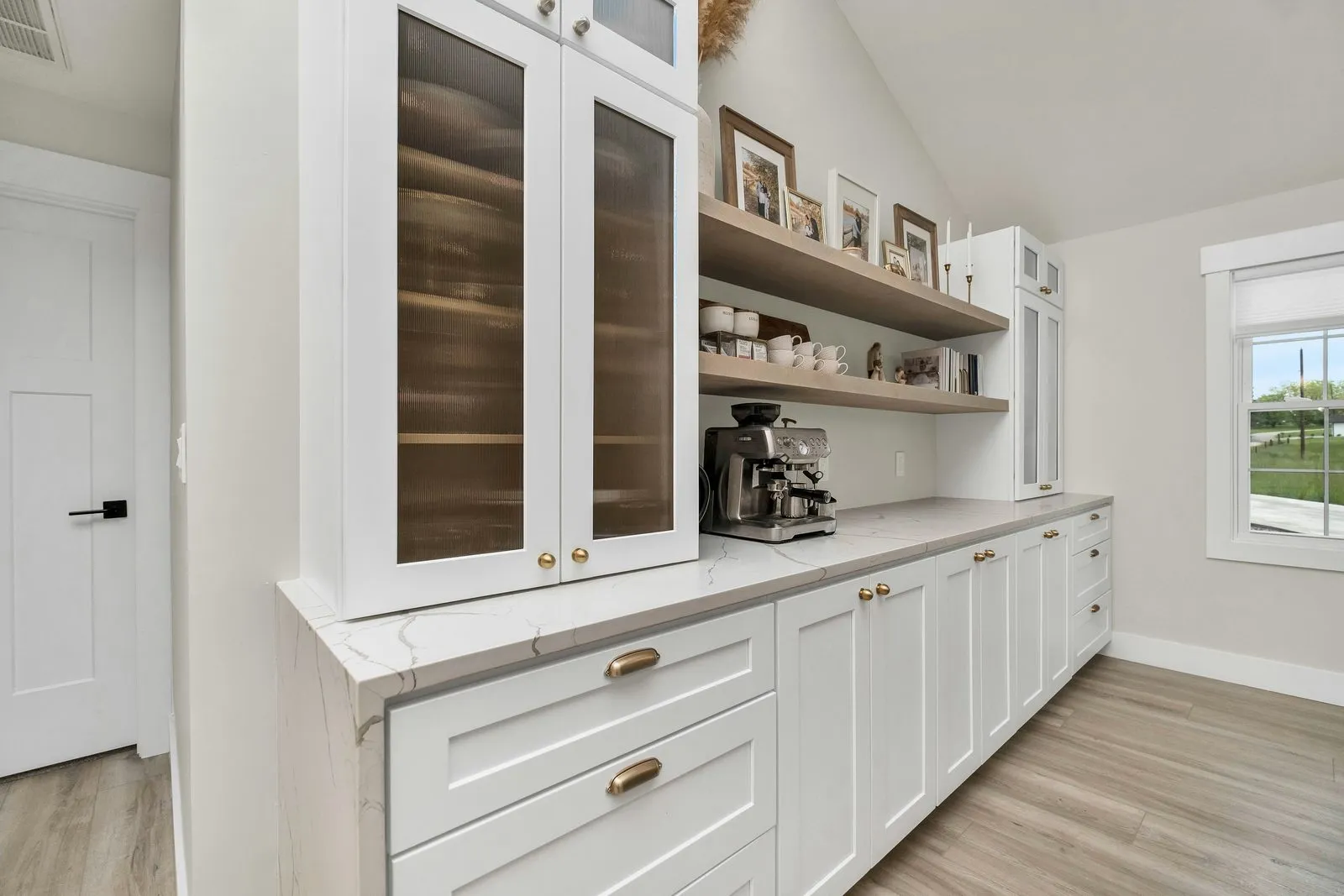 Finished white kitchen with glass-front cabinets