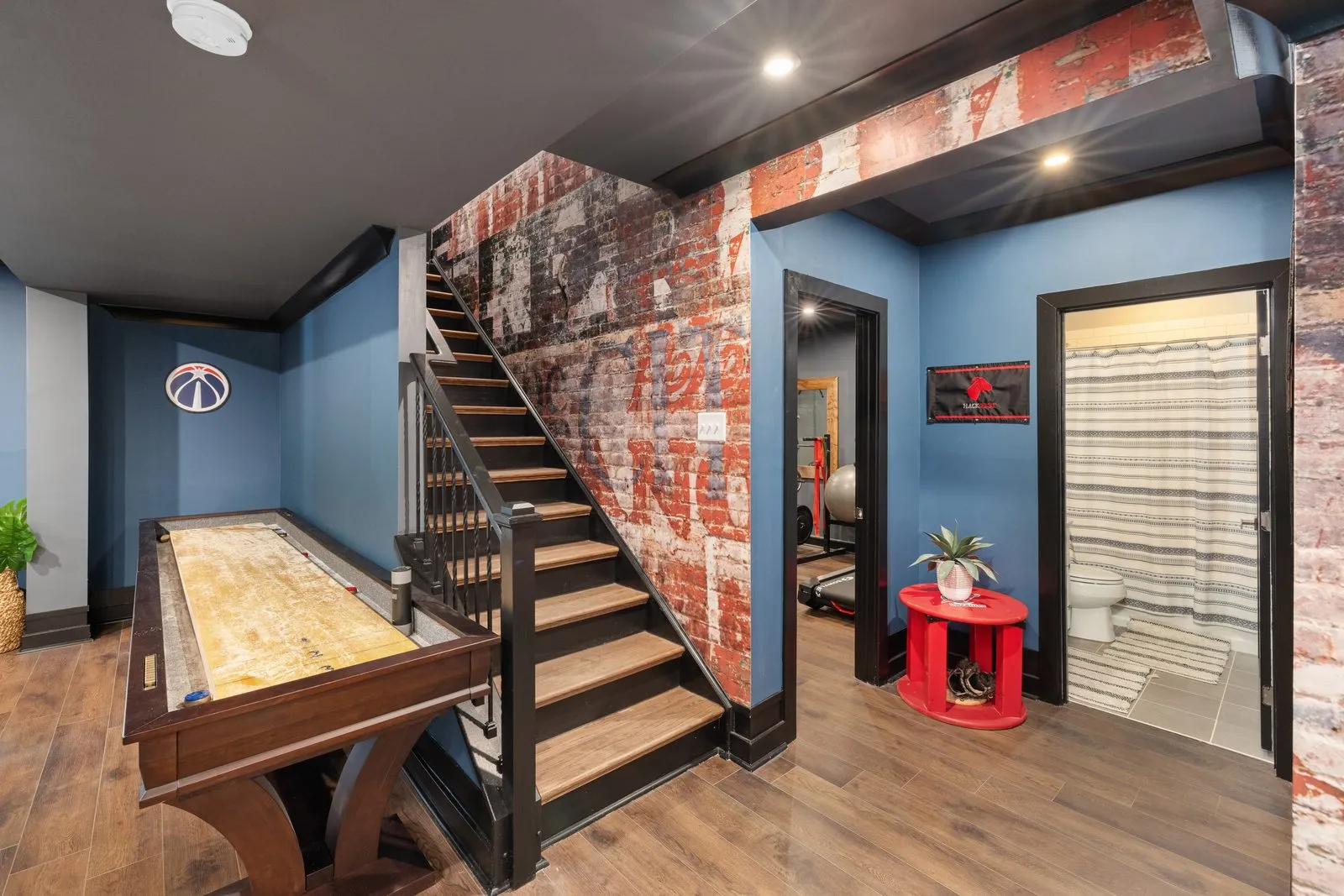 Finished basement rec room with a brick feature wall