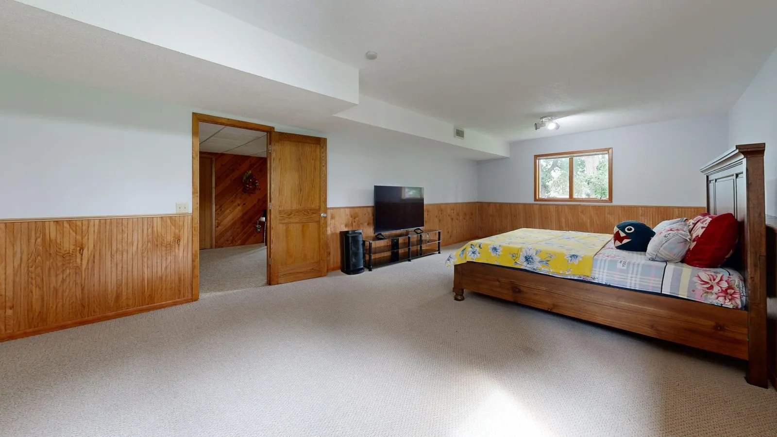 Basement bedroom with wood paneling