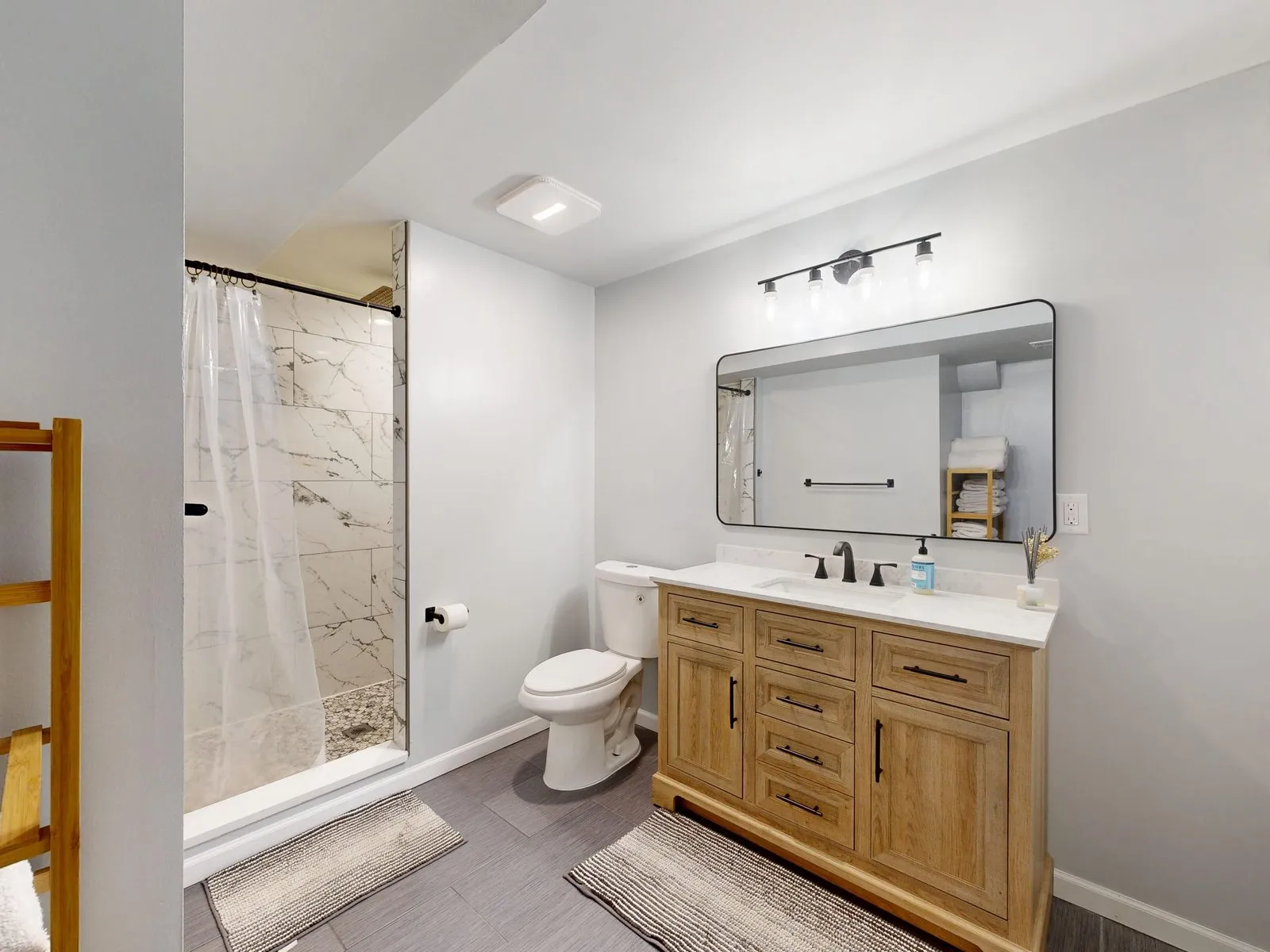 Basement bathroom with a wood vanity